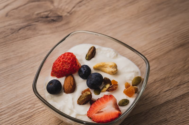 How to make yogurt. Picture of fruit and nuts in a bowl of yogurt.